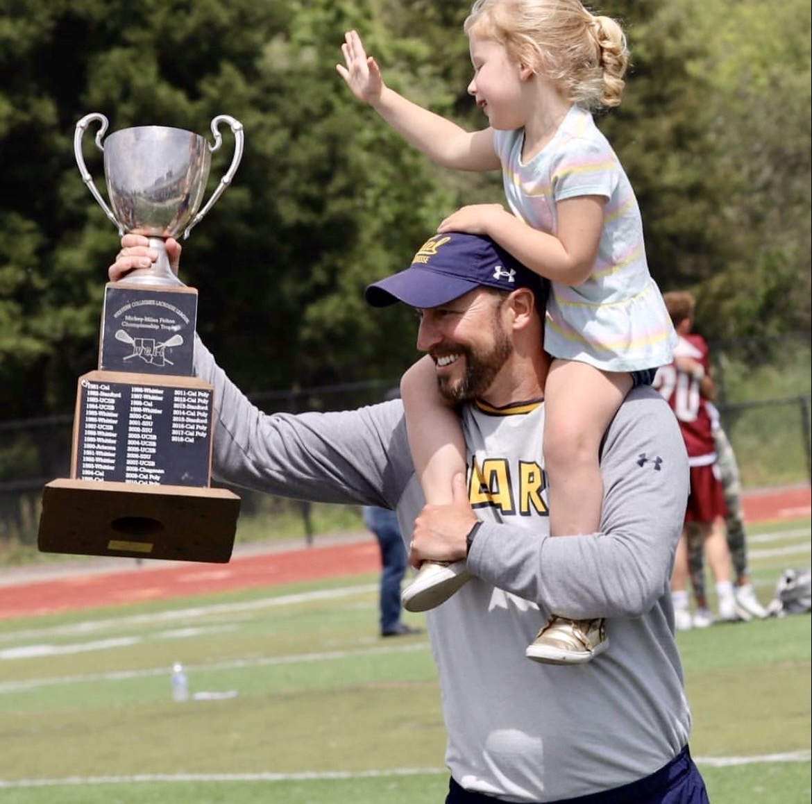Coach Ned Webster celebrating a championship win with the Cal Men's Lacrosse team